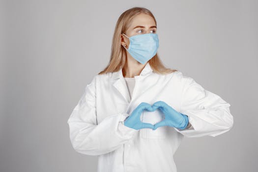 A young female healthcare professional wearing protective gear, symbolizing care and compassion.
